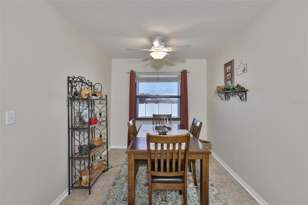 1806 Wedge Court Sun City Center, FL 33573 - Photo 25 of 53 a view of a dining room with furniture window and wooden floor