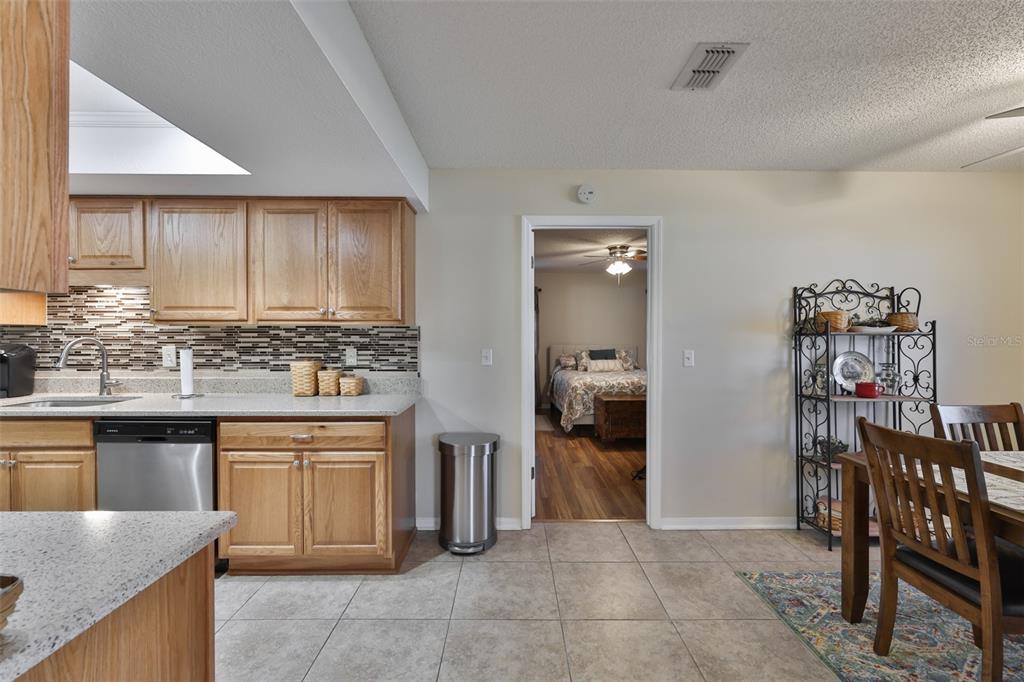 1806 Wedge Court Sun City Center, FL 33573 - Photo 26 of 53 a kitchen with stainless steel appliances granite countertop a sink and cabinets