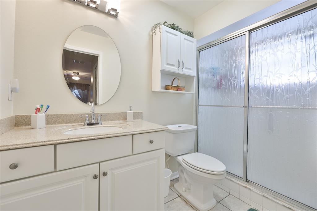 1806 Wedge Court Sun City Center, FL 33573 - Photo 31 of 53 a bathroom with a toilet a sink a mirror a vanity and shower