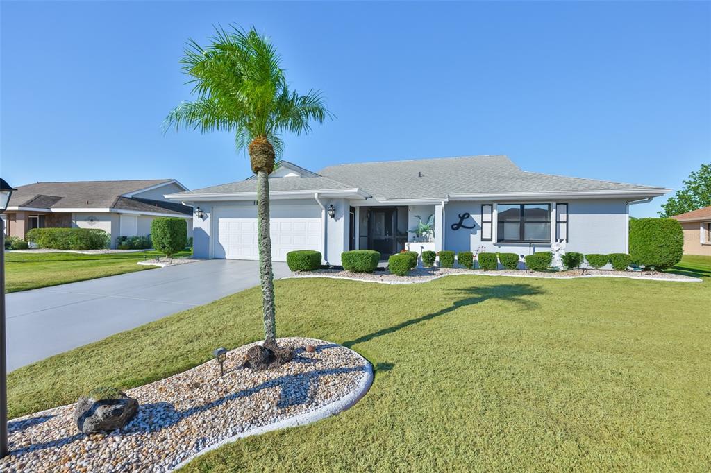 1806 Wedge Court Sun City Center, FL 33573 - Photo 4 of 53 a front view of a house with garden