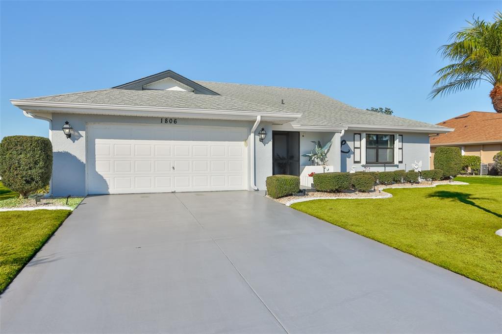 1806 Wedge Court Sun City Center, FL 33573 - Photo 6 of 53 a front view of a house with a yard and garage