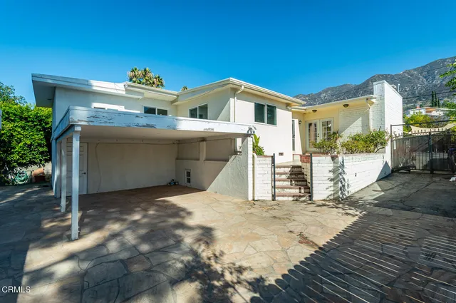 a view of a room with furniture and wooden floor