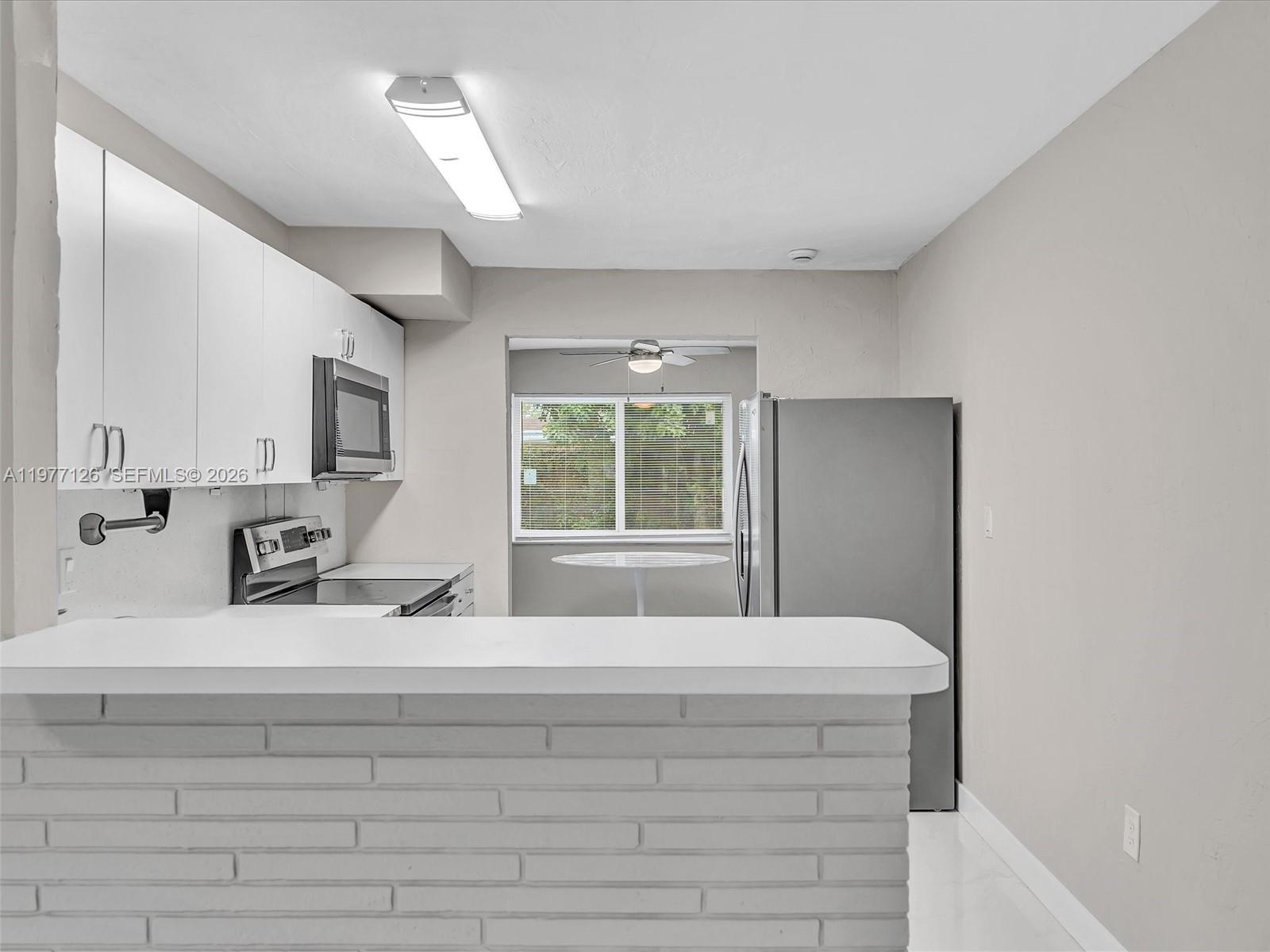 6800 Raleigh Street Hollywood, FL 33024 - Photo 15 of 42 a bedroom with a bed and a dresser with mirror