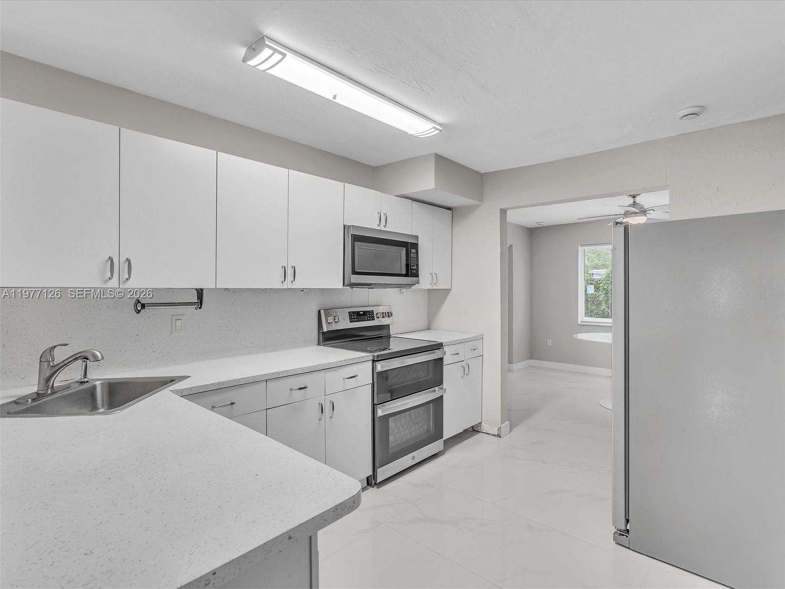 6800 Raleigh Street Hollywood, FL 33024 - Photo 17 of 42 a kitchen with cabinets stainless steel appliances and a sink