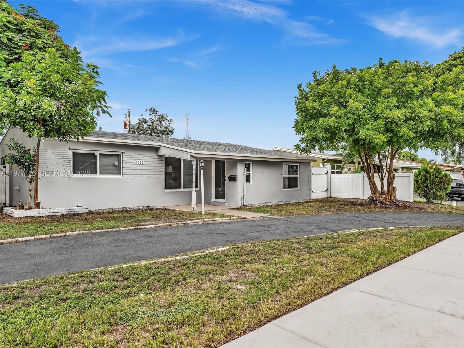 6800 Raleigh Street Hollywood, FL 33024 - Photo 2 of 42 a view of a yard in front of a house with large trees