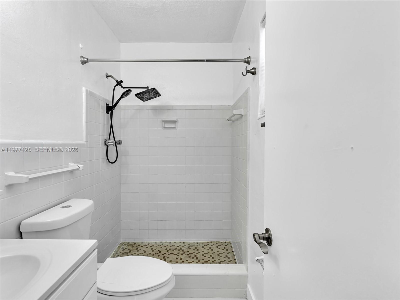 6800 Raleigh Street Hollywood, FL 33024 - Photo 23 of 42 a white toilet sitting next to a bath tub