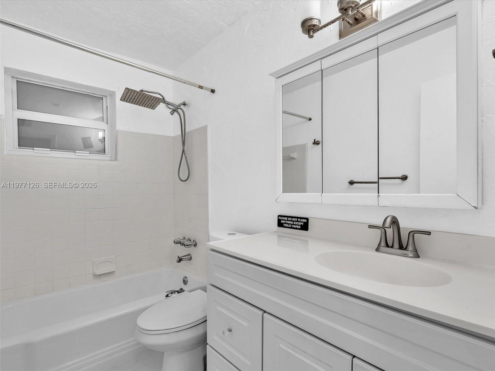 6800 Raleigh Street Hollywood, FL 33024 - Photo 24 of 42 a bathroom with a double vanity sink toilet mirror and shower