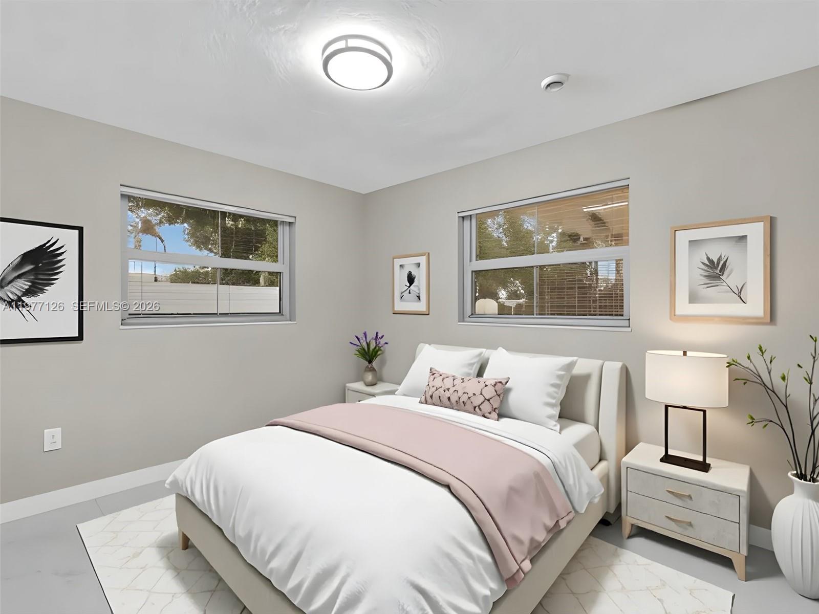 6800 Raleigh Street Hollywood, FL 33024 - Photo 27 of 42 a bedroom with a large bed and a painting on the wall