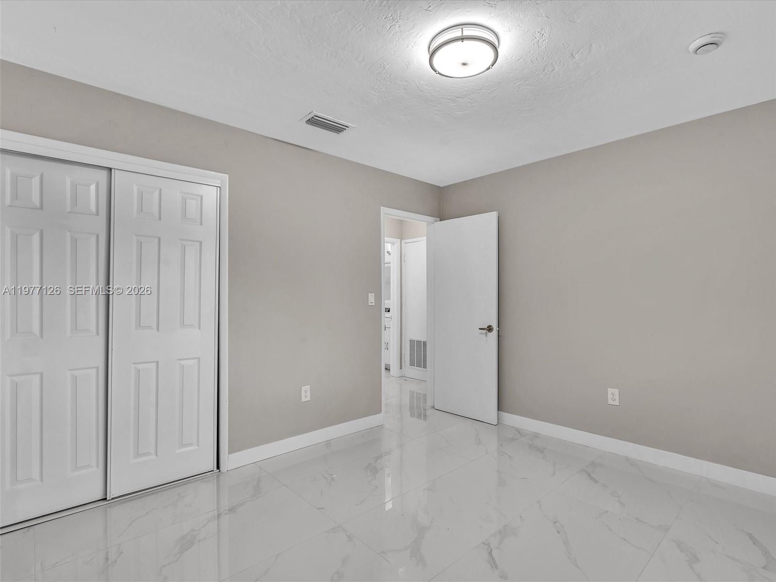 6800 Raleigh Street Hollywood, FL 33024 - Photo 28 of 42 an empty room with windows and closet