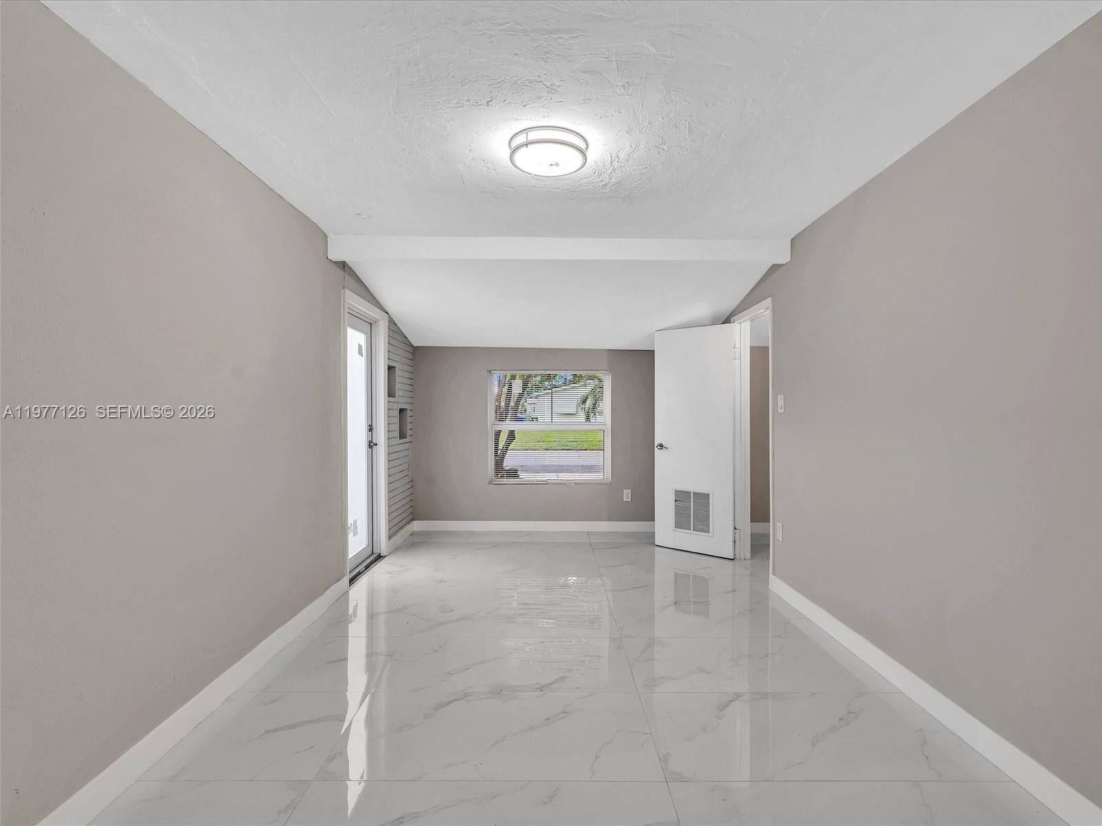 6800 Raleigh Street Hollywood, FL 33024 - Photo 32 of 42 a view of livingroom with hardwood floor and window