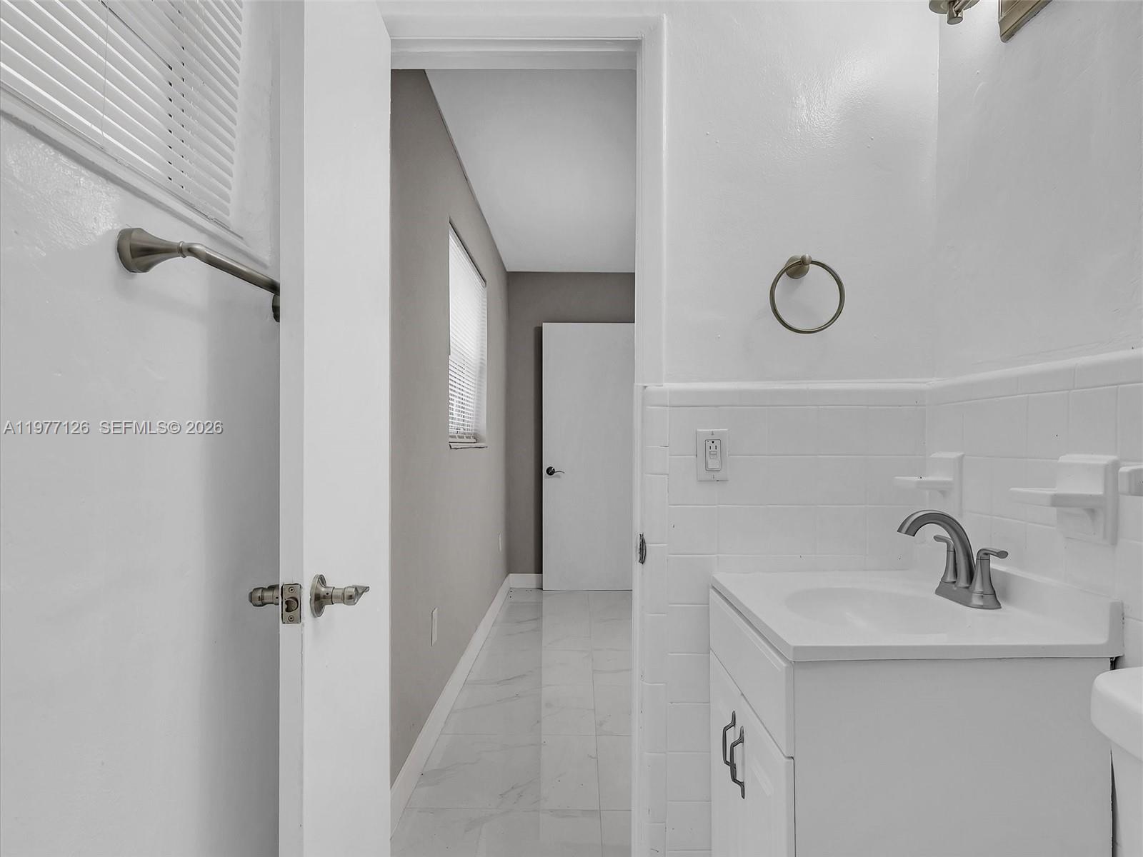 6800 Raleigh Street Hollywood, FL 33024 - Photo 33 of 42 a bathroom with a sink and mirror