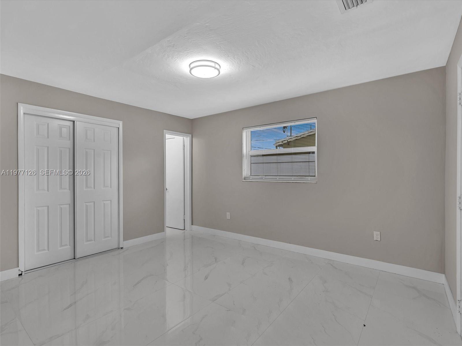 6800 Raleigh Street Hollywood, FL 33024 - Photo 37 of 42 an empty room with windows and closet