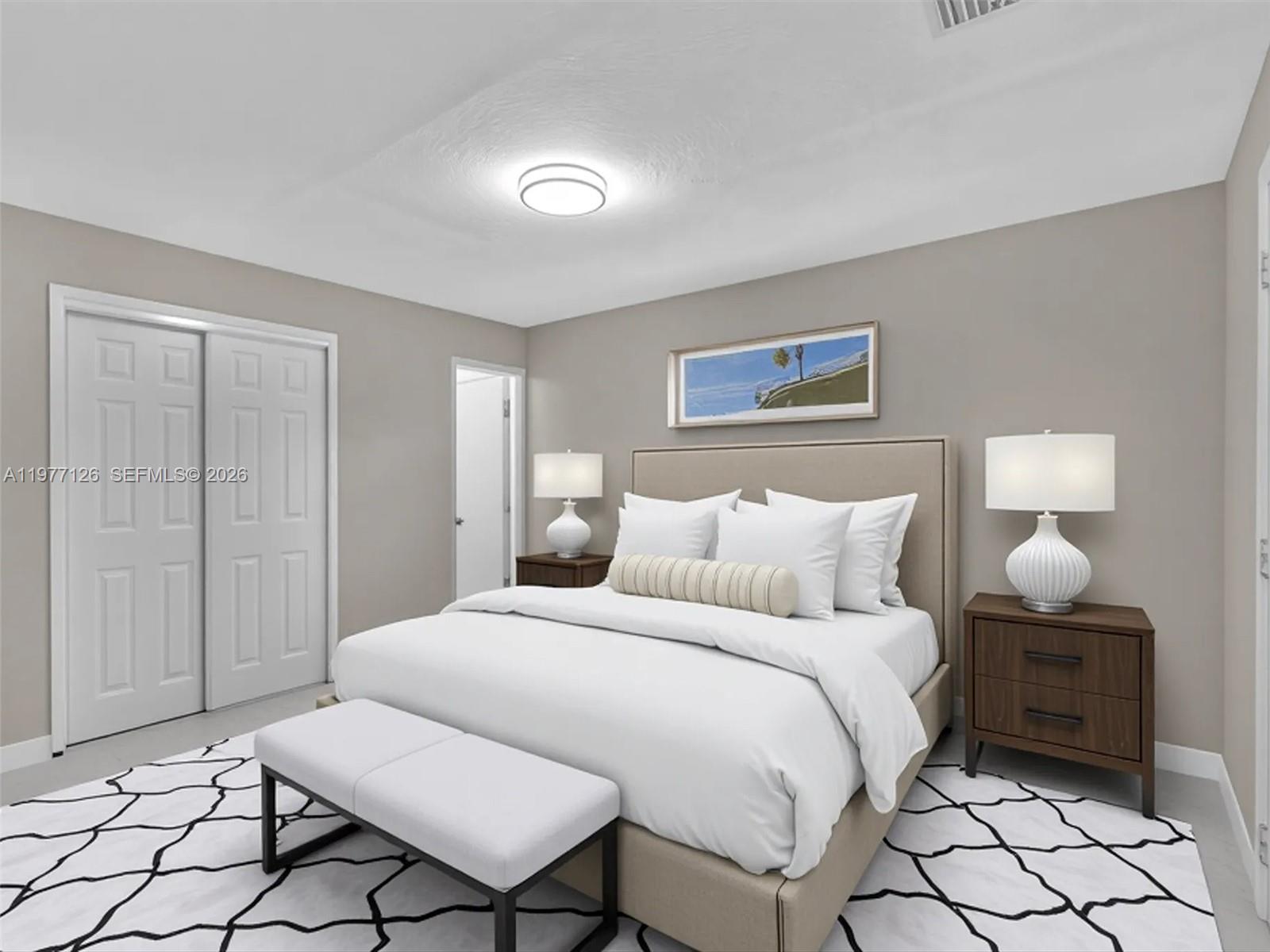 6800 Raleigh Street Hollywood, FL 33024 - Photo 38 of 42 a spacious bedroom with a bed and a lamp on table