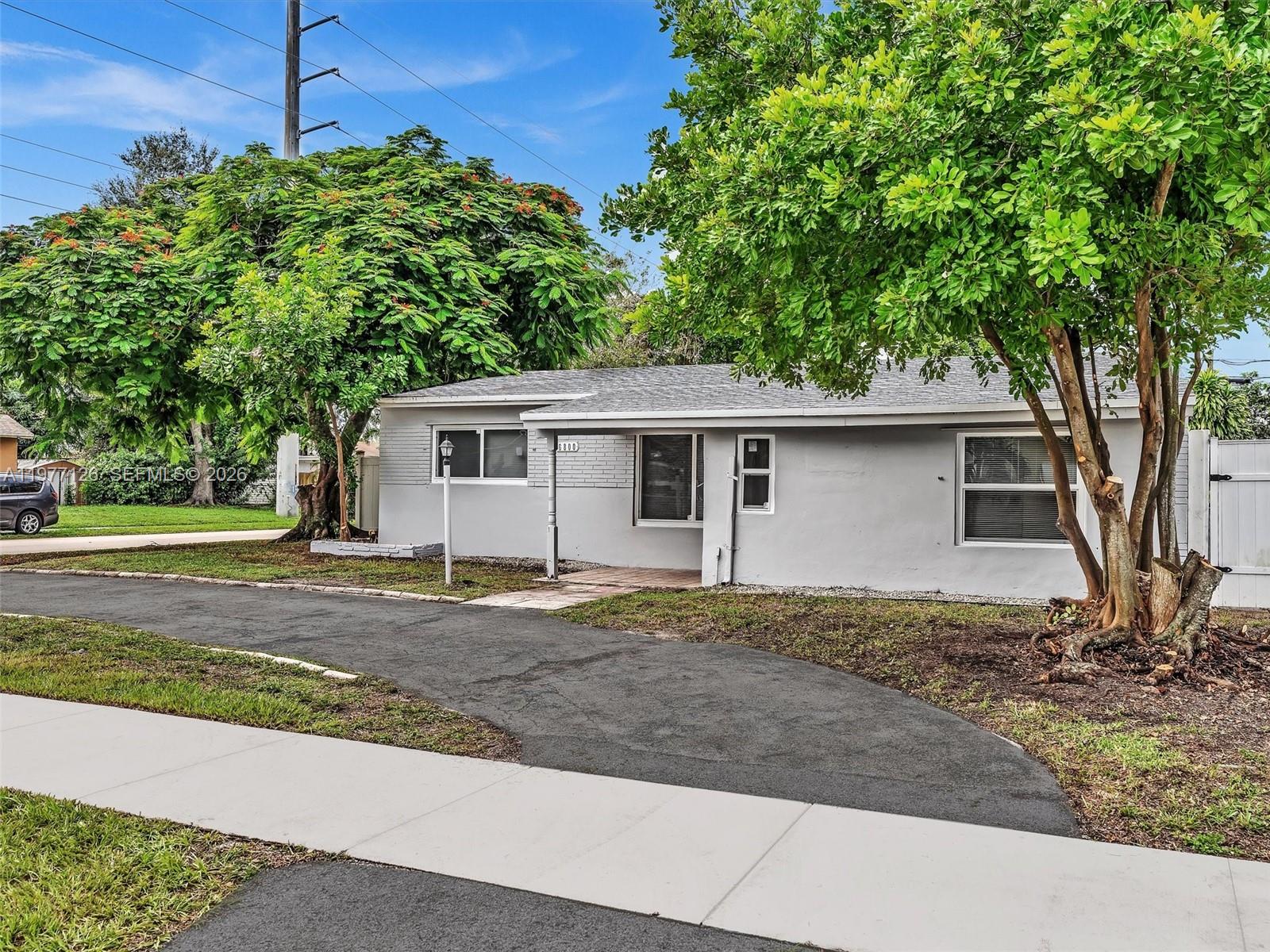 6800 Raleigh Street Hollywood, FL 33024 - Photo 40 of 42 a view of a house with a yard and large tree