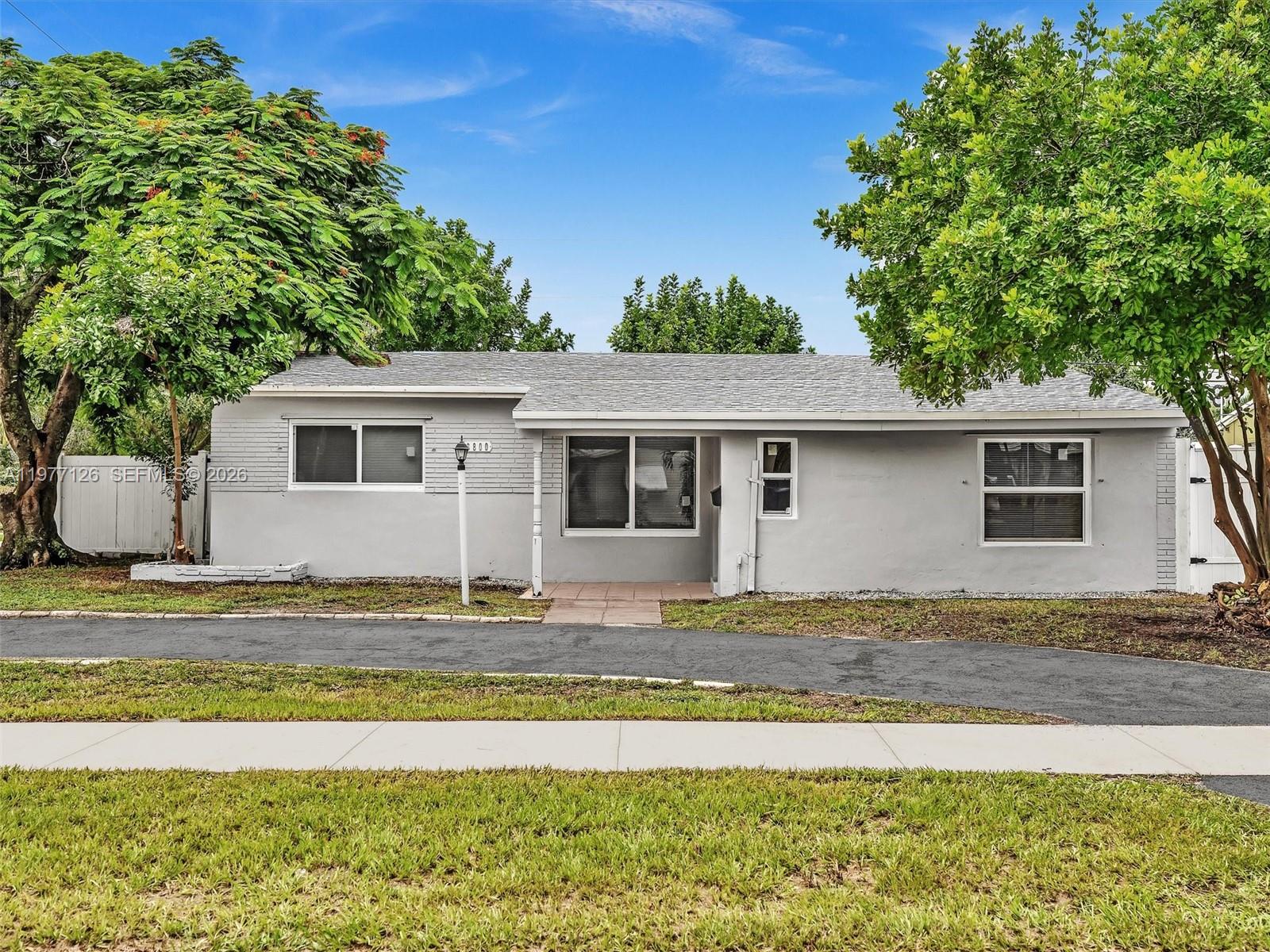 6800 Raleigh Street Hollywood, FL 33024 - Photo 41 of 42 a front view of a house with a garden