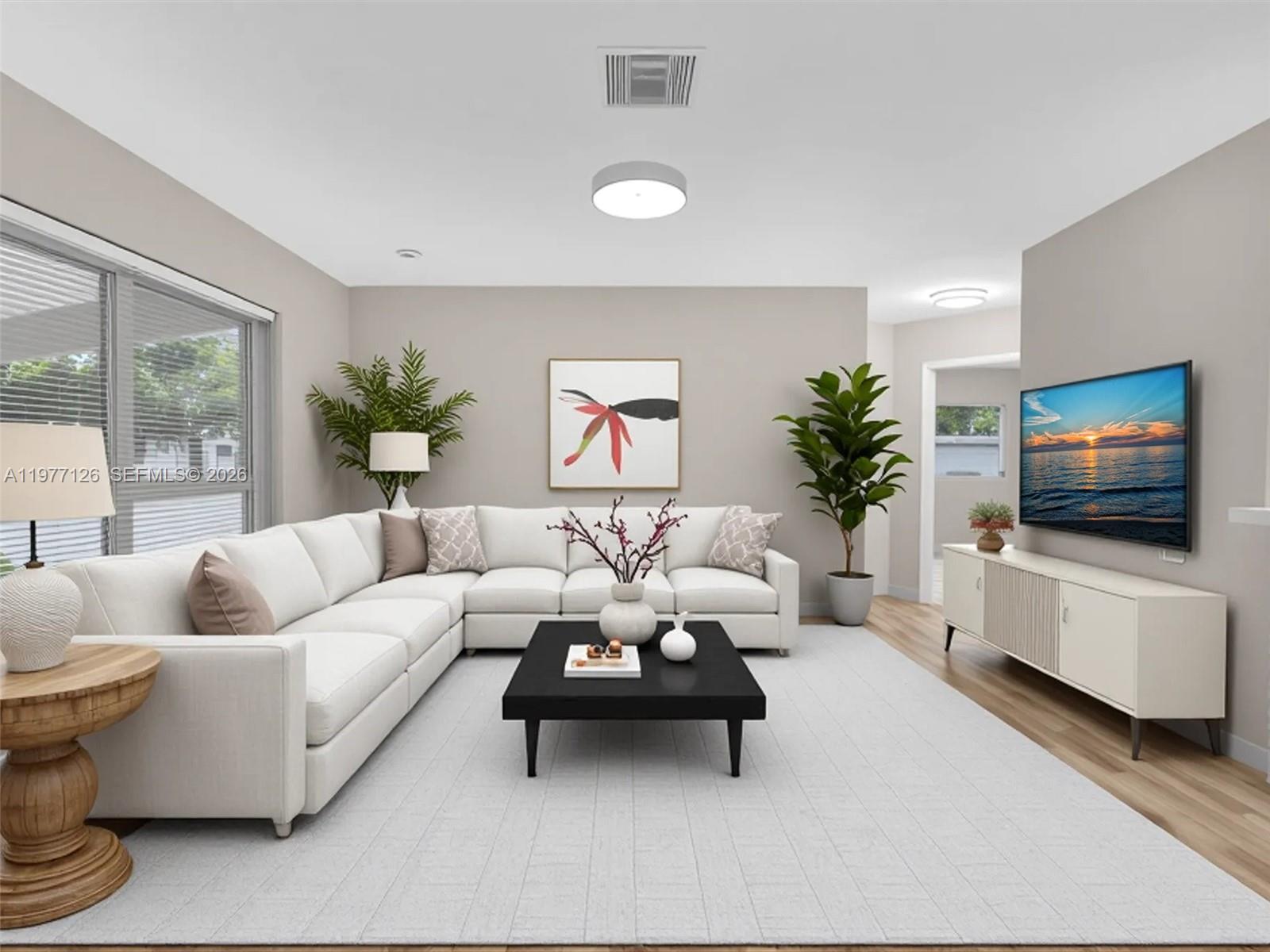 6800 Raleigh Street Hollywood, FL 33024 - Photo 9 of 42 a living room with furniture and a flat screen tv