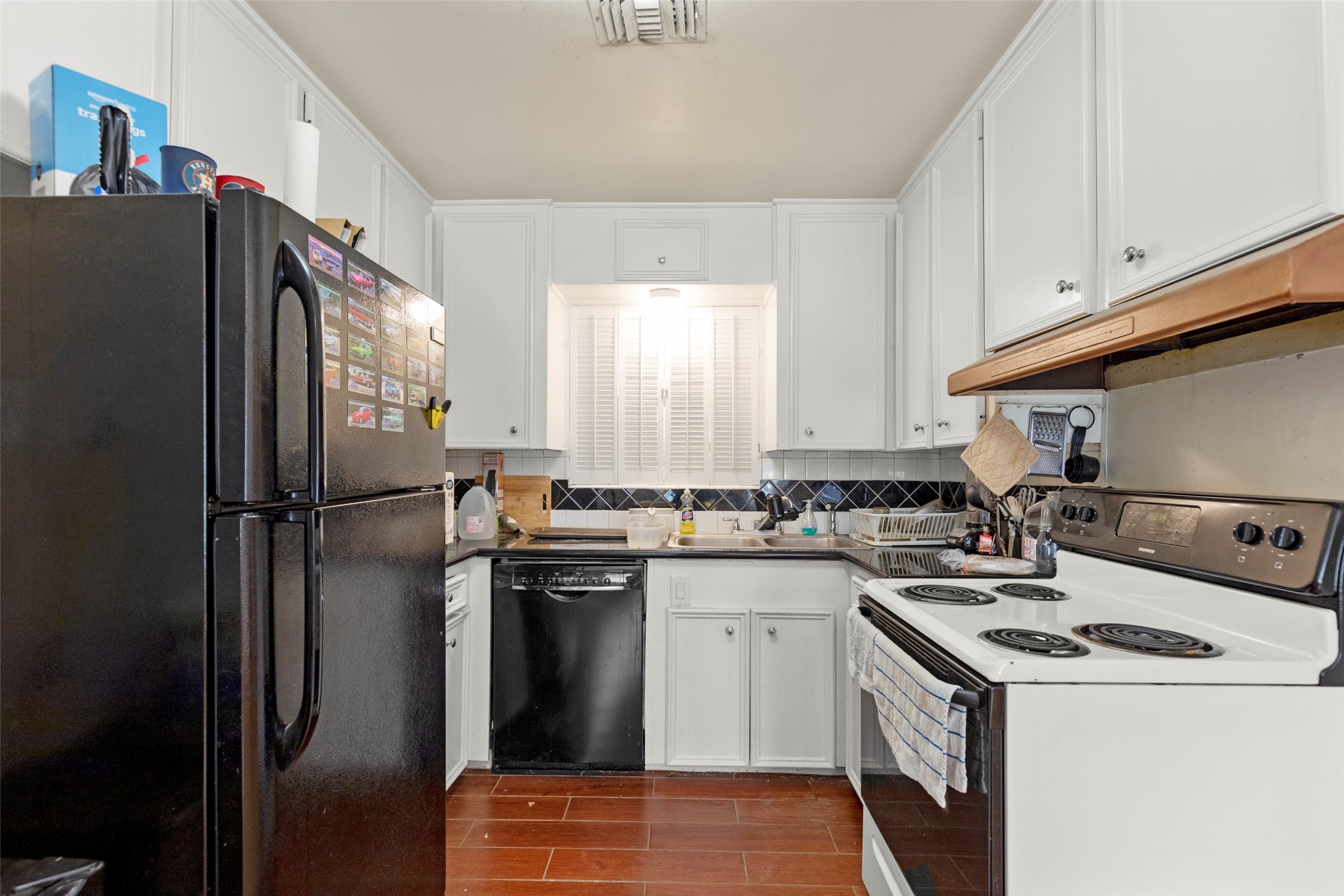 4709 Sanford Road Houston, TX 77035 - Photo 8 of 19 a kitchen with a sink a refrigerator and cabinets