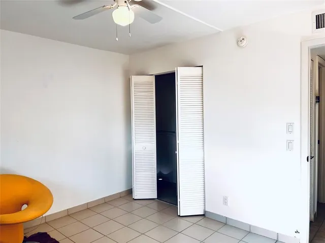 an empty room with wooden floor and closet