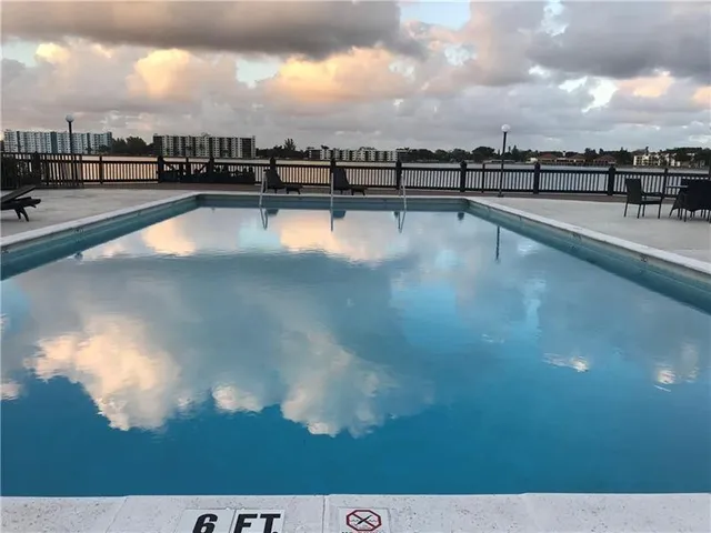 a view of a swimming pool and a yard