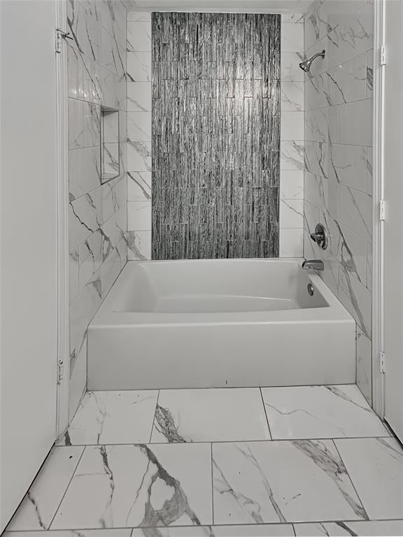 1321 Emily Road, Unit 4101 Dallas, TX 75203 - Photo 7 of 11 a bathroom with a bathtub and shower