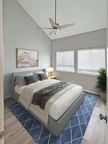 a bedroom with a large bed and a window