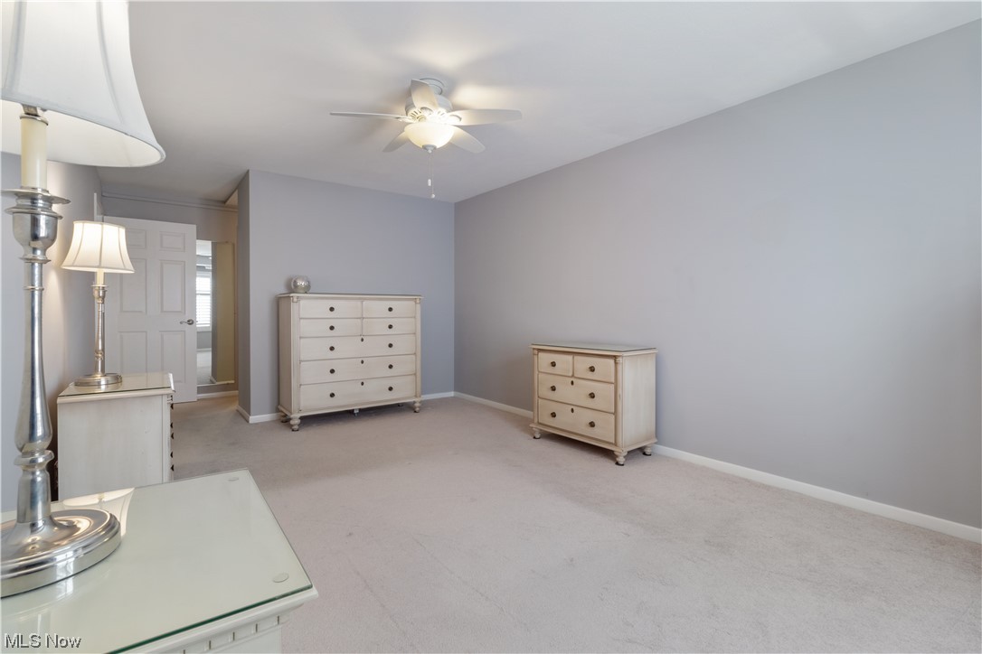 22555 Center Ridge Road, Unit 303 Rocky River, OH 44116 - Photo 21 of 33 Master bedroom featuring light carpet and ceiling fan