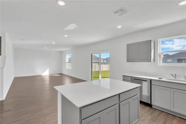 a kitchen with a sink and a refrigerator