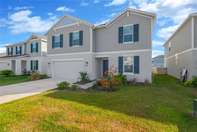 a front view of house with yard and green space