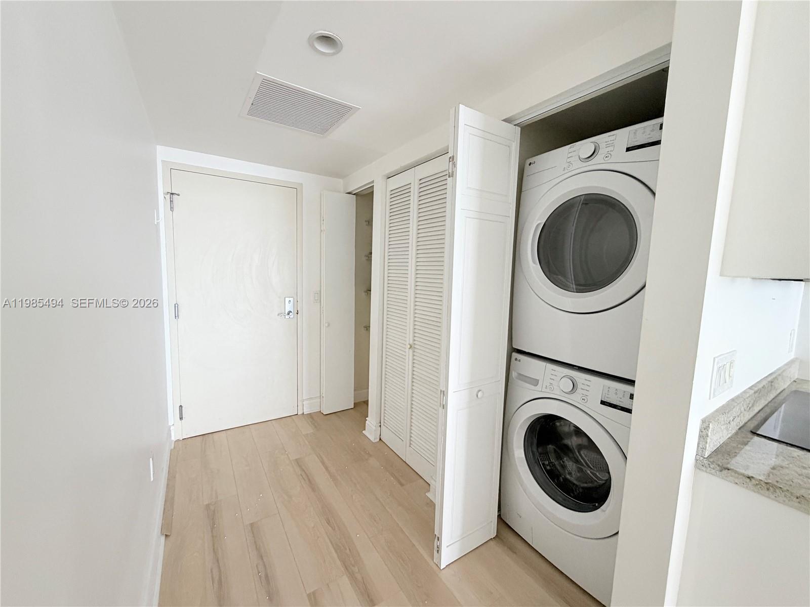 185 Southwest 7th Street, Unit 3304 Miami, FL 33130 - Photo 2 of 17 a view of a hallway with washer and dryer