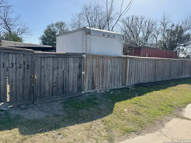 a backyard of a house with plants and trees