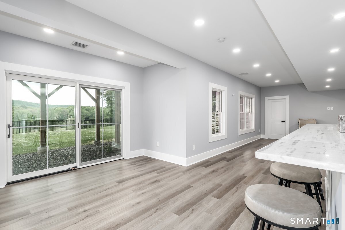 2 Pond View Lane Sherman, CT 06784 - Photo 31 of 40 a living room with wooden floor furniture and a large window
