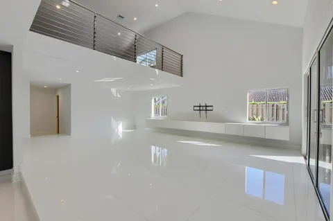 a bedroom with a large bed and a view of balcony