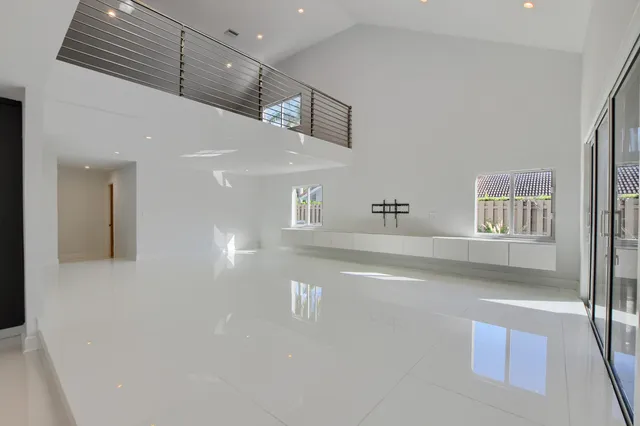 a bedroom with a large bed and a view of balcony