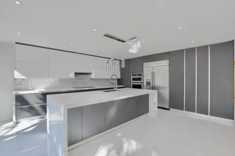 a spacious bedroom with a bed and a potted plant