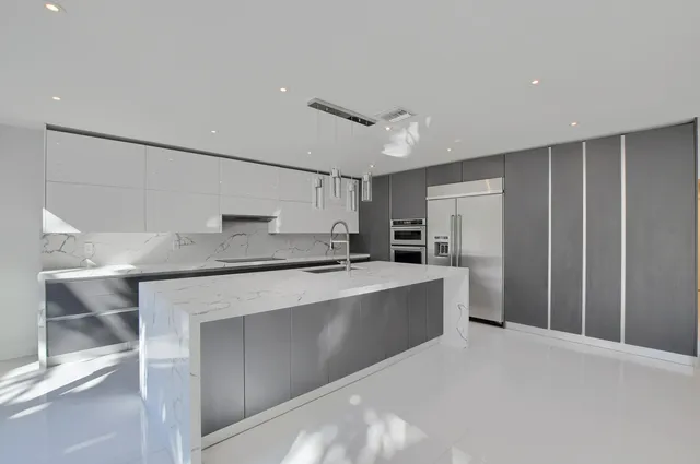 a spacious bedroom with a bed and a potted plant