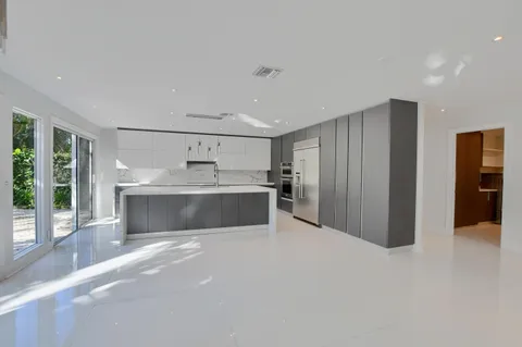 a living room with furniture and large windows