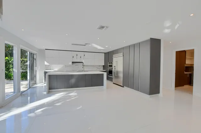 a living room with furniture and large windows