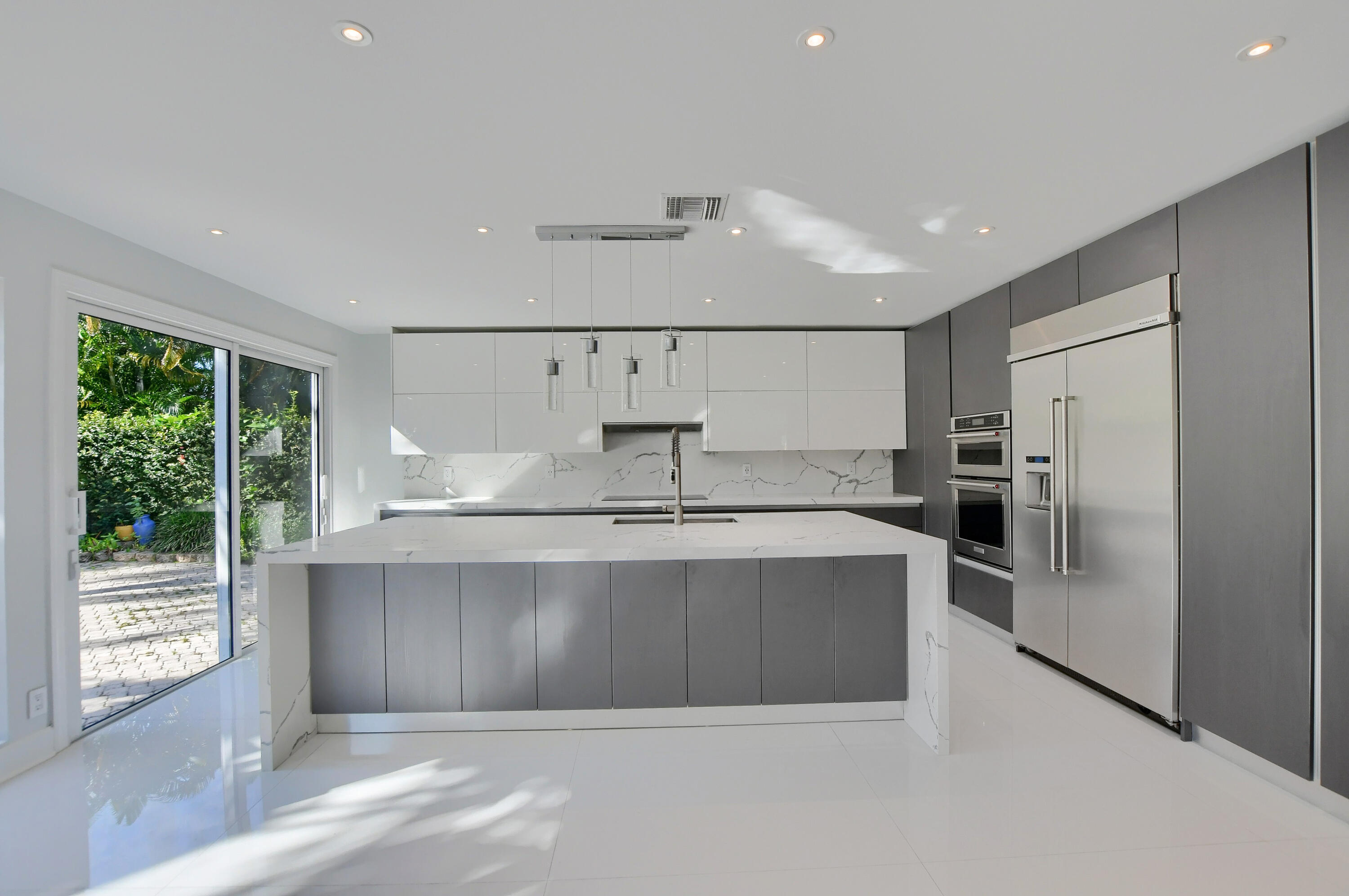 23352 Lago Mar Circle Boca Raton, FL 33433 - Photo 16 of 78 a view of a kitchen with refrigerator and windows