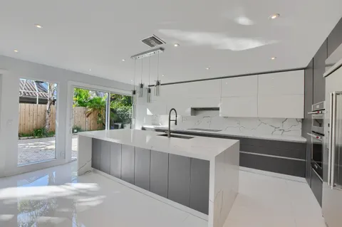 a white toilet sitting next to a shower