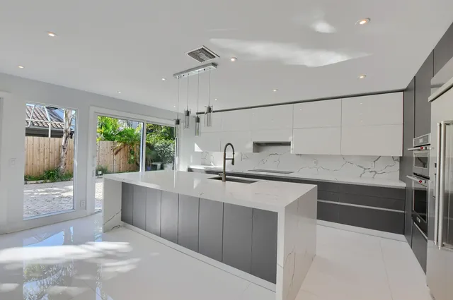 a white toilet sitting next to a shower
