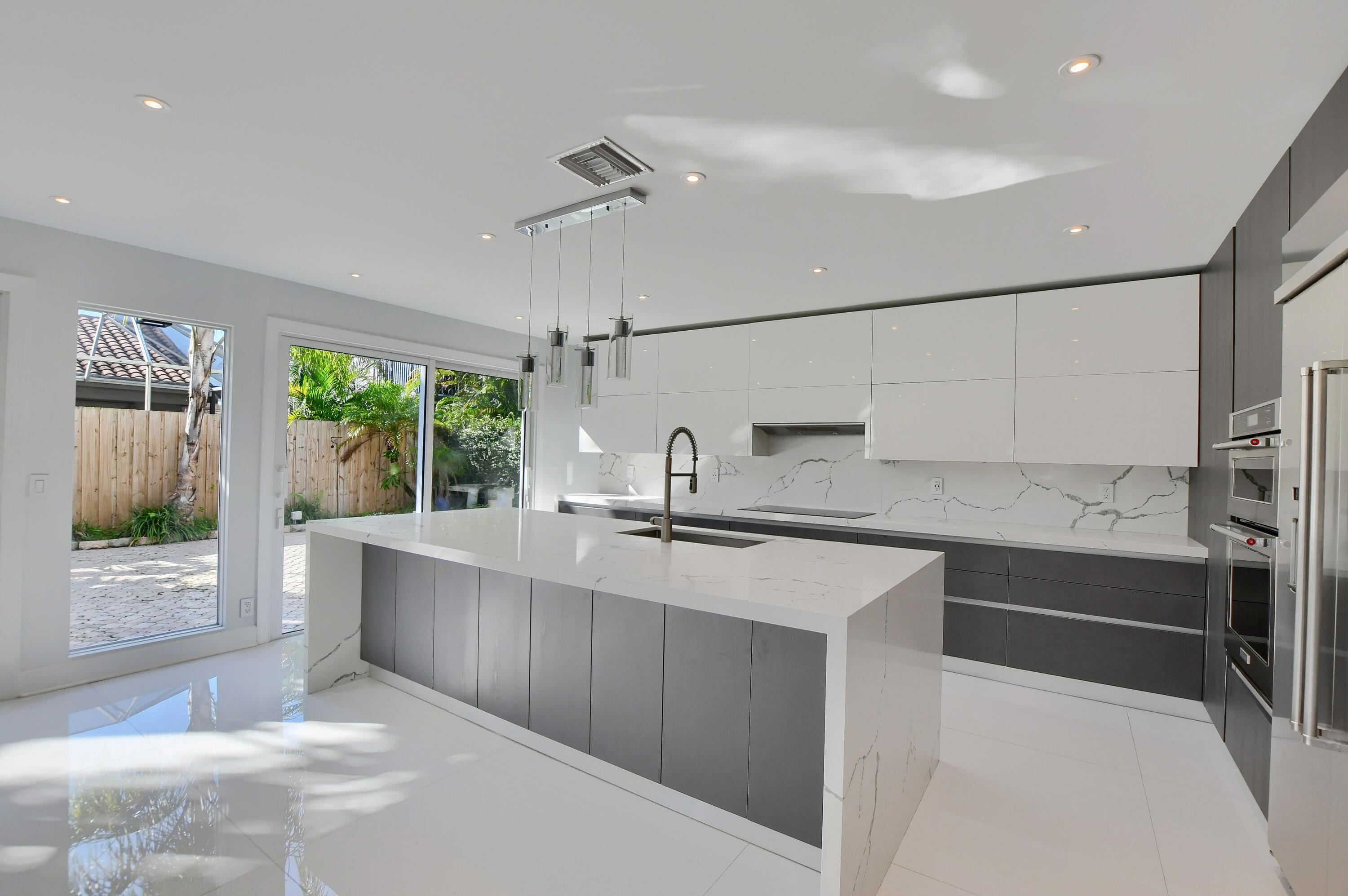 23352 Lago Mar Circle Boca Raton, FL 33433 - Photo 17 of 78 a kitchen with a sink and cabinets