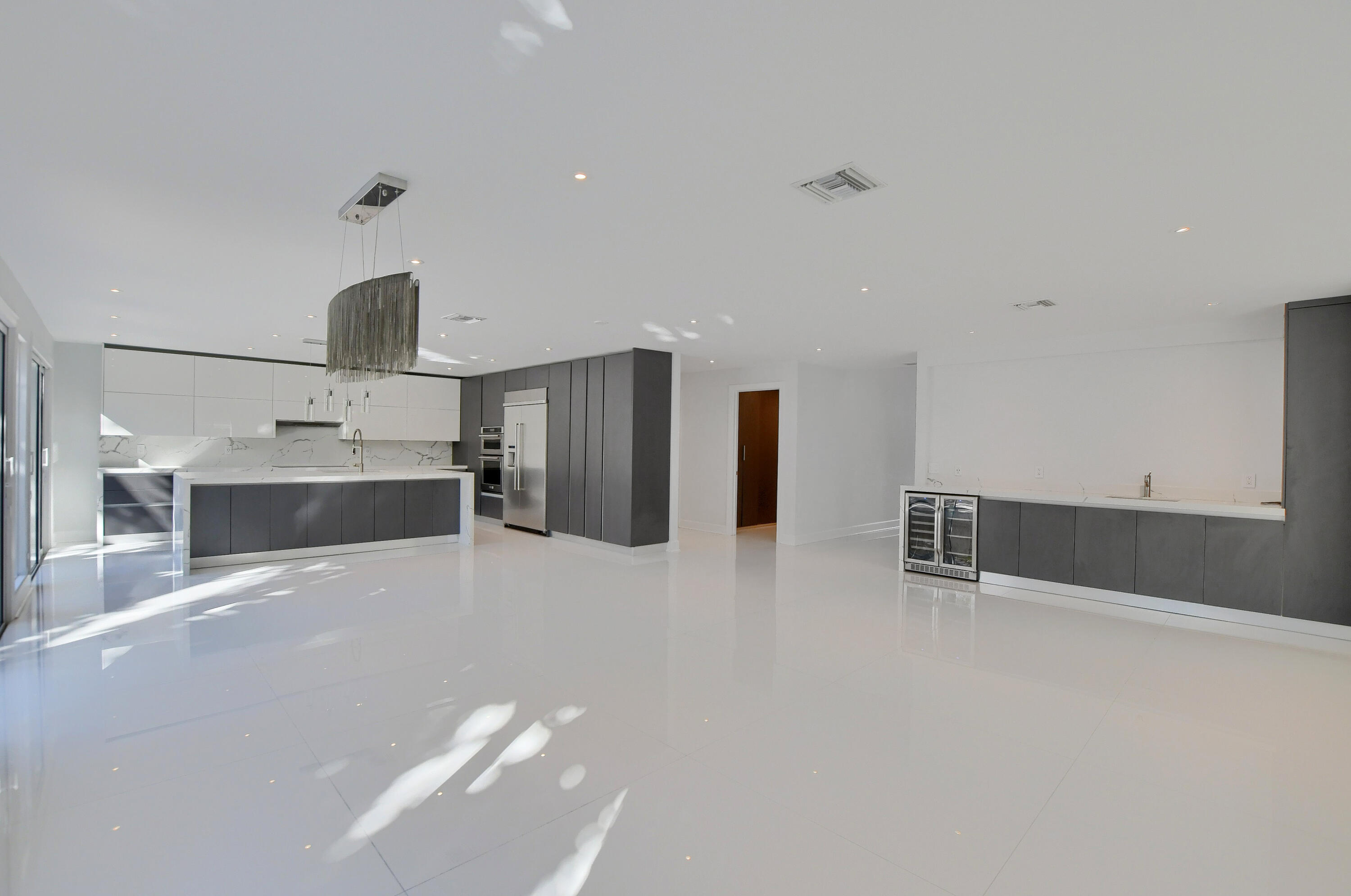 23352 Lago Mar Circle Boca Raton, FL 33433 - Photo 20 of 78 a large white kitchen with stainless steel appliances a large counter top