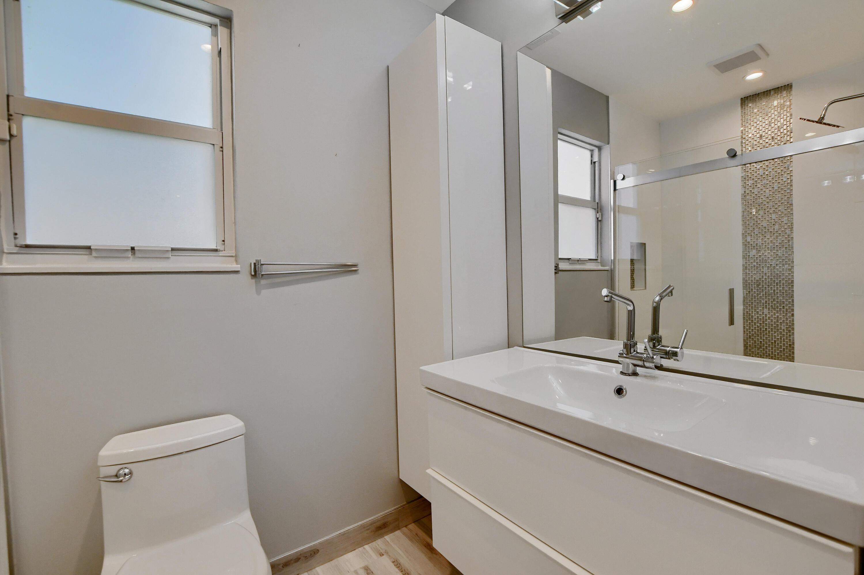 23352 Lago Mar Circle Boca Raton, FL 33433 - Photo 32 of 78 a bathroom with a sink a toilet and a mirror