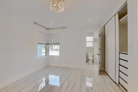 a view of a room with wooden floor and a large window