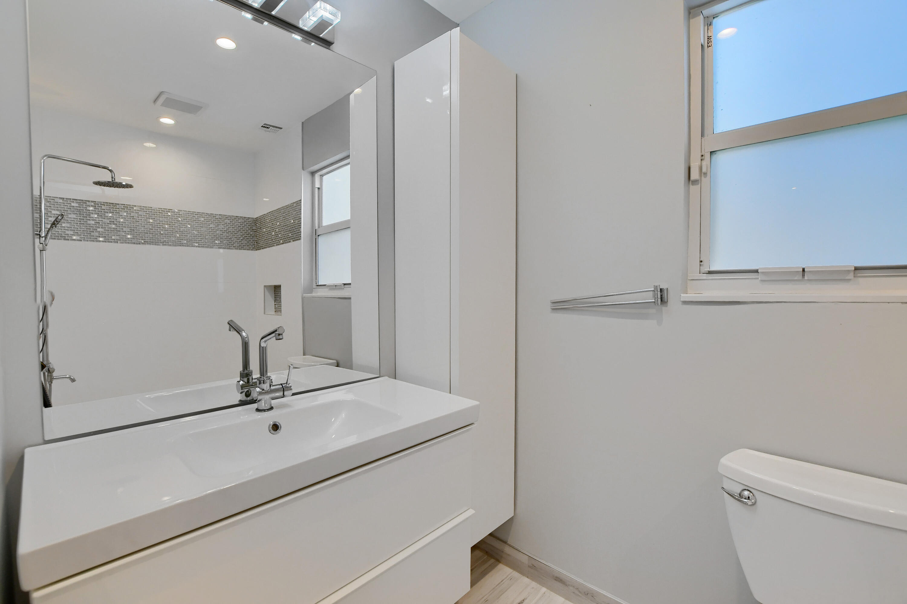 23352 Lago Mar Circle Boca Raton, FL 33433 - Photo 35 of 78 a bathroom with a sink a toilet and a mirror