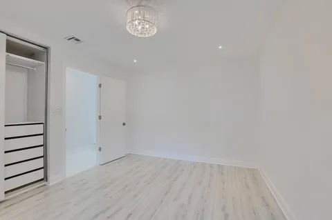 a bathroom with a granite countertop sink a mirror and a bathtub