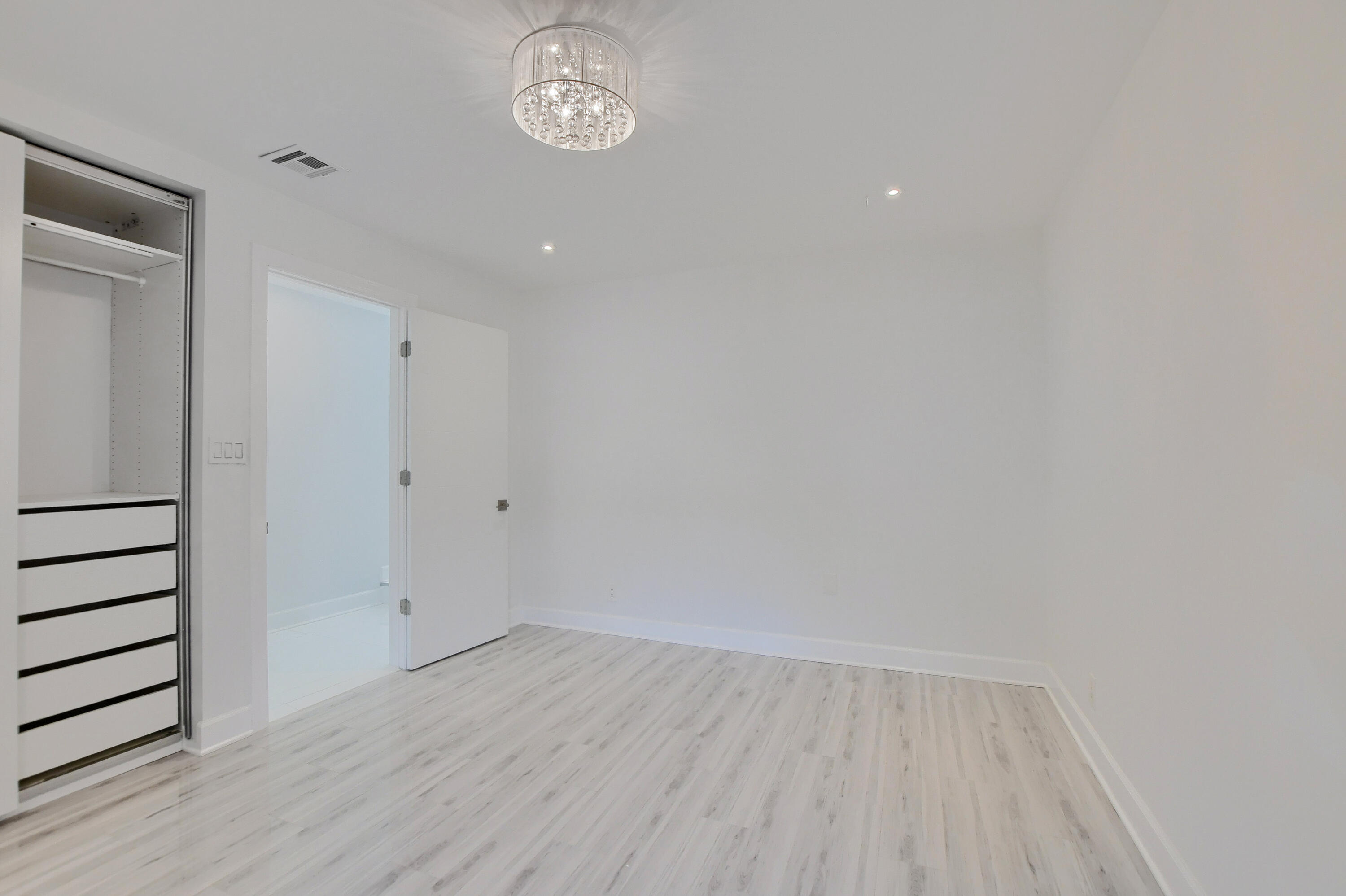 23352 Lago Mar Circle Boca Raton, FL 33433 - Photo 36 of 78 a view of a room with wooden floor and white walls