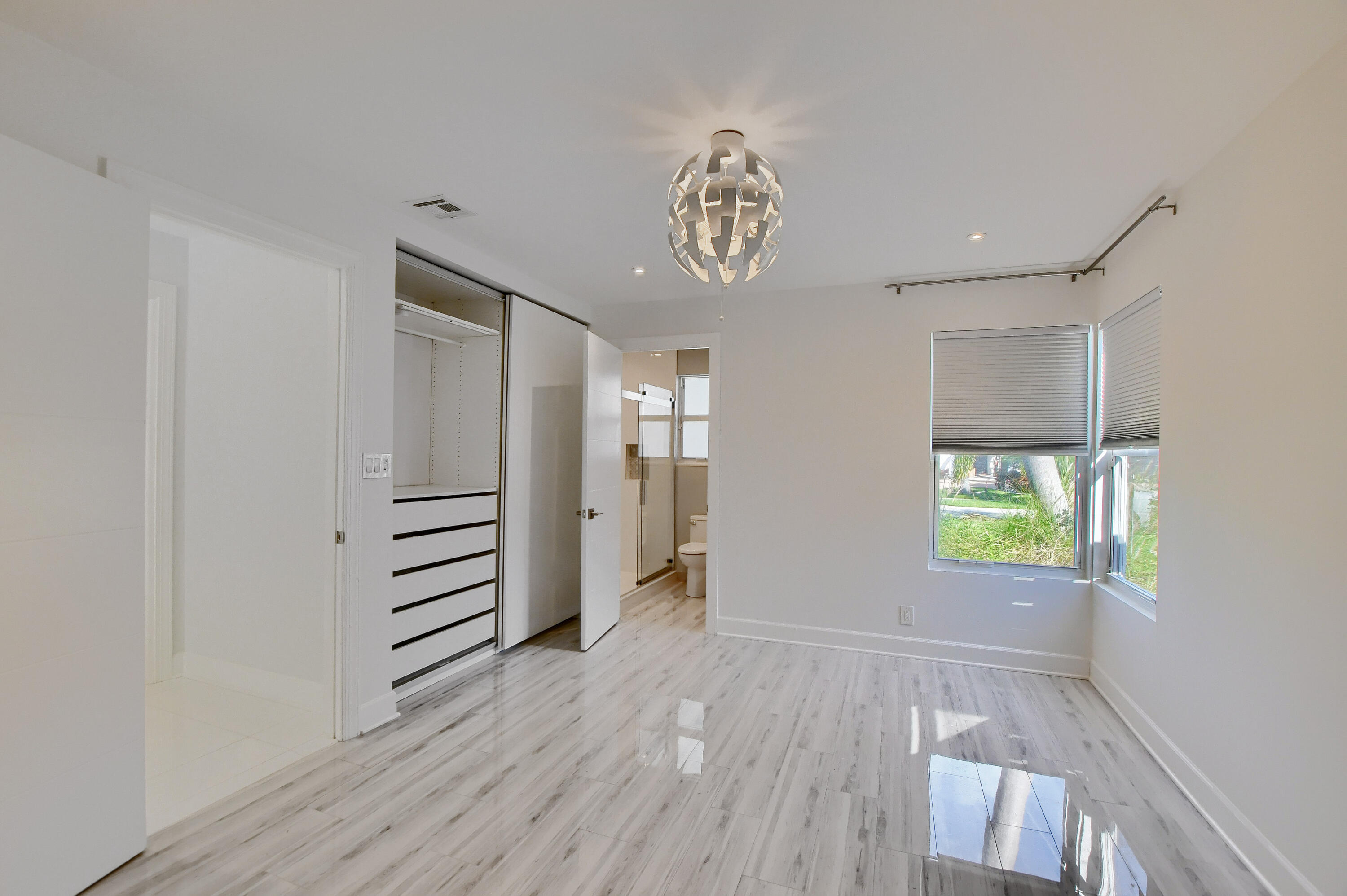 23352 Lago Mar Circle Boca Raton, FL 33433 - Photo 38 of 78 an empty room with wooden floor and windows