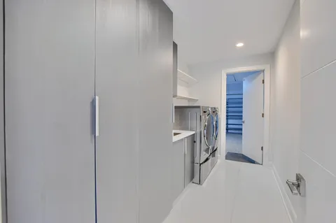 a view of a house with pool and sitting area