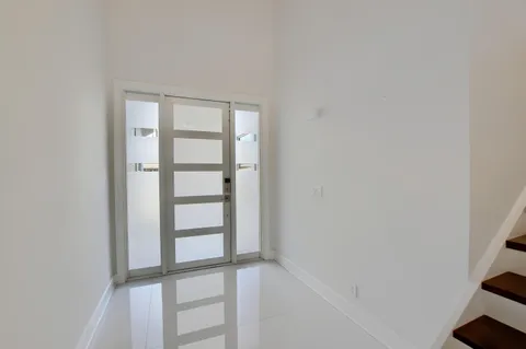 a kitchen with a sink a counter top space and living room area